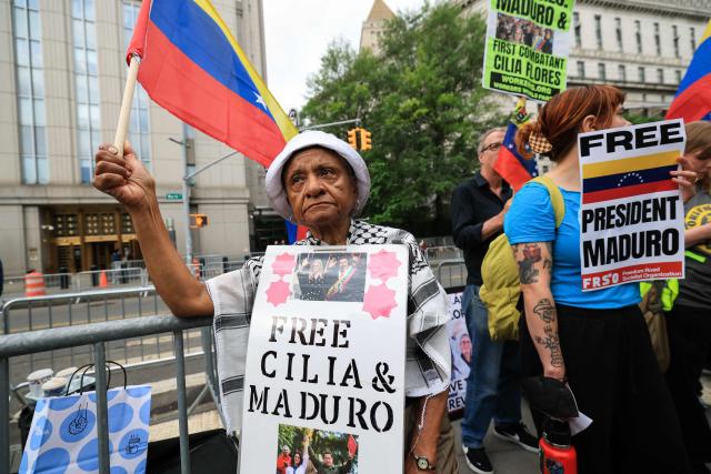 Demonstrators hold signs in support of ousted Venezuelan president Nicholas Maduro and his wife Cilia Flores, outside the Daniel Patrick Moynihan Federal Courthouse in New York City on July 22, 2026. Venezuela's ousted president Nicolas Maduro is set to appear in federal court Wednesday, his third public hearing since the US military captured him in a stunning nighttime raid in January. The former leader, 63, and wife Cilia Flores have been held in a Brooklyn jail since the US military operation, awaiting trial on drug trafficking, firearms and other charges. (Photo by TIMOTHY A. CLARY / AFP)