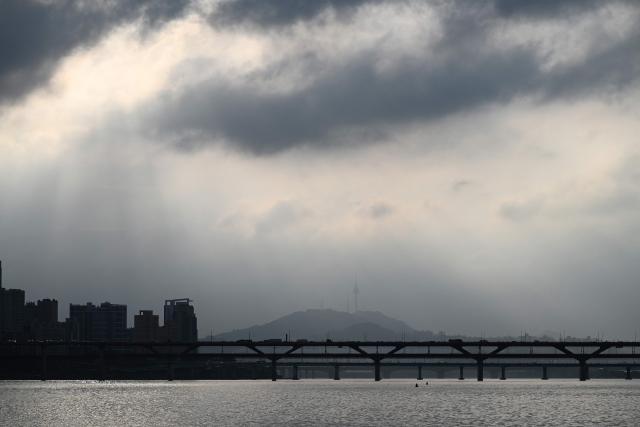 Seoul Tower is seen in the distance from a ferry on the Han River in Seoul on July 22, 2026. (Photo by GREG BAKER / AFP)