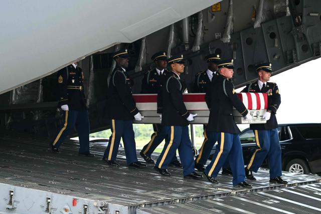 A US Army carry team carries the flag-draped transfer case containing the remains of Sgt. Michael Emmanuel Swinton, 30, of Fayetteville, North Carolina, during a dignified transfer solemn event for US service members killed during operations in the Middle East, at Dover Air Force Base in Dover, Delaware, on July 22, 2026. Swinton was killed in action on July 19 at at Erbil Air Base in Iraq. (Photo by SAUL LOEB / AFP)
