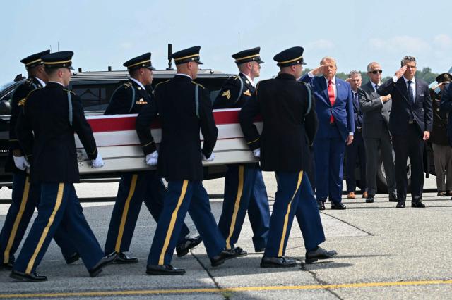 US President Donald Trump and Secretary of Defense Pete Hegseth salute as a US Army carry team carries the flag-draped transfer case containing the remains of Sgt. Angel S. Rampersad, 28, of Ozone Park, New York, during a dignified transfer solemn event for US service members killed during operations in the Middle East, at Dover Air Force Base in Dover, Delaware, on July 22, 2026. According to the US Department of Defense, Rampersad is believed to have been killed in action on July 17 during an enemy attack at Muwaffaq Salti Air Base in Jordan. (Photo by SAUL LOEB / AFP)