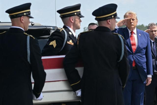 US President Donald Trump salutes as a US Army carry team carries the flag-draped transfer case containing the remains of Sgt. Angel S. Rampersad, 28, of Ozone Park, New York, during a dignified transfer solemn event for US service members killed during operations in the Middle East, at Dover Air Force Base in Dover, Delaware, on July 22, 2026. According to the US Department of Defense, Rampersad is believed to have been killed in action on July 17 during an enemy attack at Muwaffaq Salti Air Base in Jordan. (Photo by SAUL LOEB / AFP)