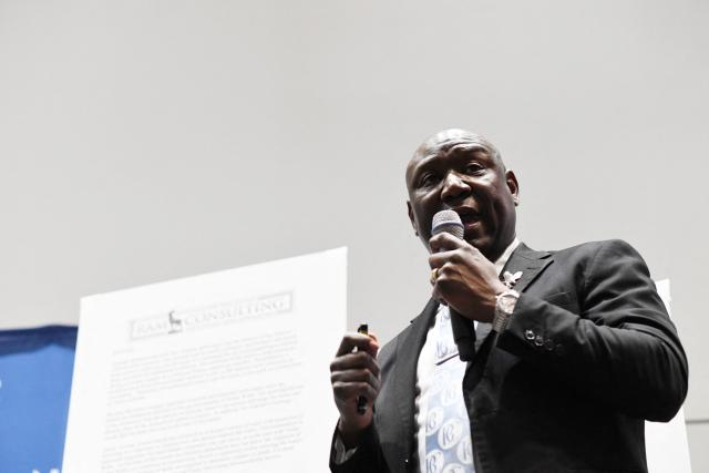 A man places a photograph of Nolan Xavier Wells in front of the podium before a news conference during the 117th NAACP National Convention at McCormick Place in Chicago, Illinois, on July 22, 2026. Crump unveiled the preliminary findings of an independent autopsy conducted on behalf of the Wells family. Nolan Xavier Wells, an 18-year-old Mississippi college student, was found dead after a boat trip with friends on July 4. (Photo by Octavio Jones / AFP)