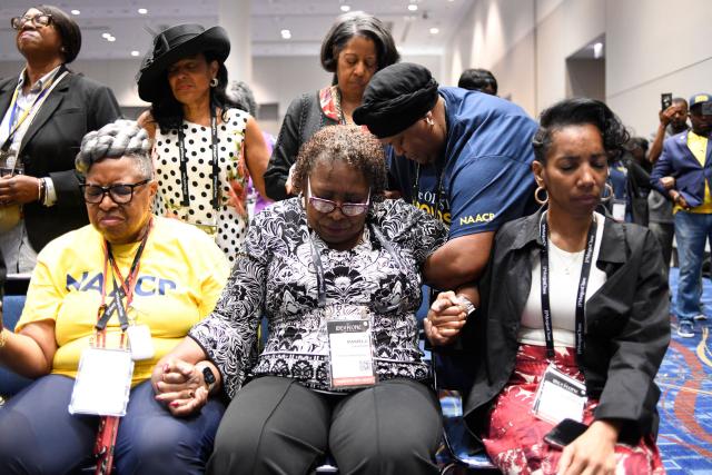 NAACP members join in a closing prayer following a news conference with civil rights and personal injury attorney Ben Crump during the 117th NAACP National Convention at McCormick Place in Chicago, Illinois, on July 22, 2026. Civil rights and personal injury attorney Ben Crump unveiled the preliminary findings of an independent autopsy conducted on behalf of the Wells family. Nolan Xavier Wells, an 18-year-old Mississippi college student, was found dead after a boat trip with friends on July 4. (Photo by Octavio Jones / AFP)