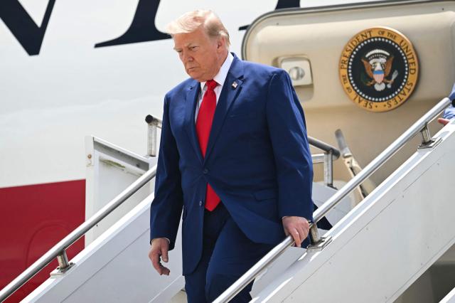 US President Donald Trump disembarks from Air Force One upon arrival at Dobbins Air Reserve Base in Marietta, Georgia, July 22, 2026. Trump is travelling to Wheeler High School in Marietta, Georgia, to deliver remarks. (Photo by SAUL LOEB / AFP)