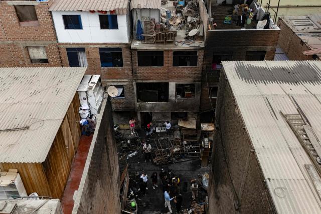 Aerial view of a house where a fire killed ten people in Lima on July 22, 2026. A fire in a low-income neighborhood in Lima killed 10 people and destroyed two homes, Peru's civil defense reported. Two more people were injured, the INDECI civil defense institute wrote in a social media post. (Photo by Ernesto BENAVIDES / AFP)