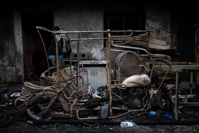 View of debris at the site of a fire that killed ten people in Lima on July 22, 2026. A fire in a low-income neighborhood in Lima killed 10 people and destroyed two homes, Peru's civil defense reported. Two more people were injured, the INDECI civil defense institute wrote in a social media post. (Photo by ERNESTO BENAVIDES / AFP)