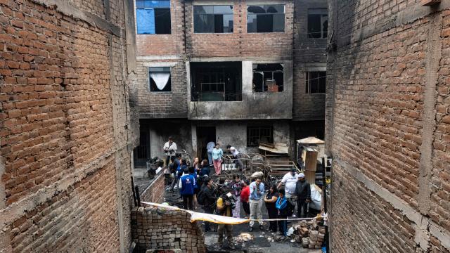Aerial view of a house where a fire killed ten people in Lima on July 22, 2026. A fire in a low-income neighborhood in Lima killed 10 people and destroyed two homes, Peru's civil defense reported. Two more people were injured, the INDECI civil defense institute wrote in a social media post. (Photo by Ernesto BENAVIDES / AFP)
