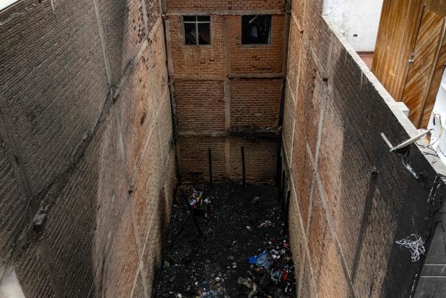 Aerial view of a house where a fire killed ten people in Lima on July 22, 2026. A fire in a low-income neighborhood in Lima killed 10 people and destroyed two homes, Peru's civil defense reported. Two more people were injured, the INDECI civil defense institute wrote in a social media post. (Photo by Ernesto BENAVIDES / AFP)