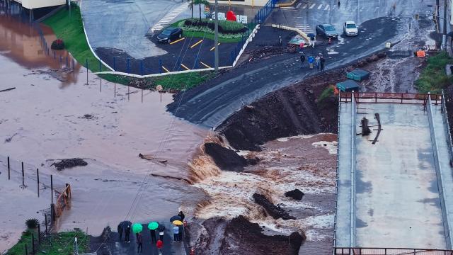 This aerial view shows floodwaters from the Taquari River inundating a side road along General Daltro Filho Street in Roca Sales, Rio Grande do Sul state, Brazil, on July 22, 2026. (Photo by Gustavo Ghisleni / AFP)
