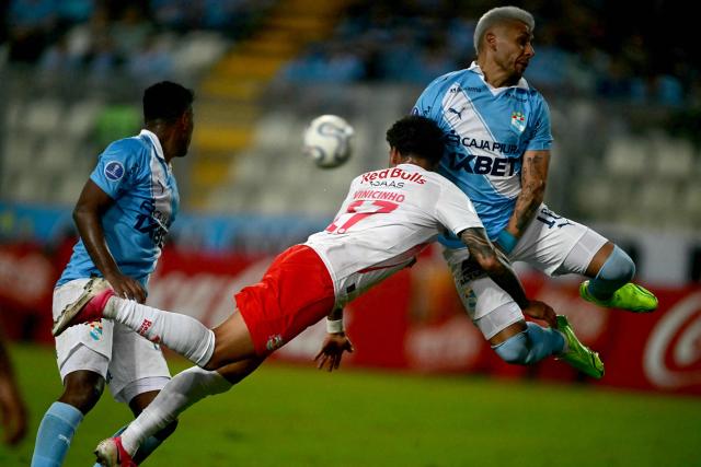 Red Bull Bragantino's forward #17 Vinicinho (C) and Sporting Cristal's Argentine defender #18 Juan Cruz Gonzalez (R) jump to head the ball during the first leg of the Copa Sudamericana knockout round play-off football match between Peru's Sporting Cristal and Brazil's Red Bull Bragantino, at the Nacional stadium in Lima, on July 22, 2026. (Photo by ERNESTO BENAVIDES / AFP)