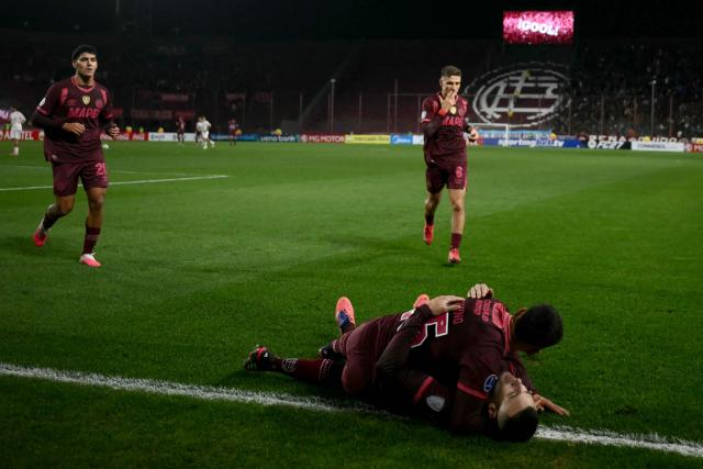 Lanus' midfielder #23 Ramiro Carrera celebrates with teammate midfielder #25 Dylan Aquino after scoring his team's second goal during the first leg of the Copa Sudamericana knockout round play-off football match between Argentina's Lanus and Peru's Cienciano, at the Ciudad de Lanus stadium, in Lanus, Buenos Aires province, Argentina on July 22, 2026. (Photo by Luis ROBAYO / AFP)