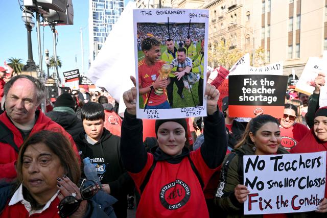 Teachers march through Melbourne's city centre to protest over pay and conditions on July 23, 2026. Tens of thousands of public school teachers went on strike following a pay dispute with the state government, closing or disrupting some 500 state schools. (Photo by William WEST / AFP)