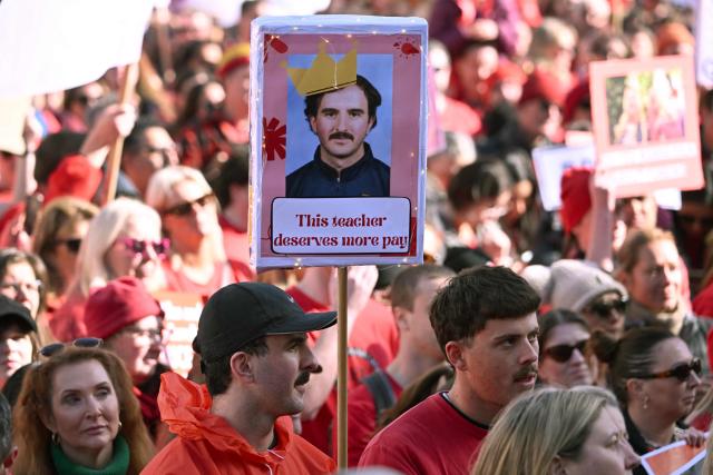 Teachers march through Melbourne's city centre to protest over pay and conditions on July 23, 2026. Tens of thousands of public school teachers went on strike following a pay dispute with the state government, closing or disrupting some 500 state schools. (Photo by William WEST / AFP)
