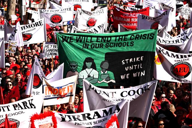 Teachers march through Melbourne's city centre to protest over pay and conditions on July 23, 2026. Tens of thousands of public school teachers went on strike following a pay dispute with the state government, closing or disrupting some 500 state schools. (Photo by William WEST / AFP)