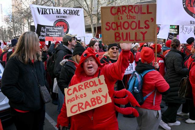 Teachers march through Melbourne's city centre to protest over pay and conditions on July 23, 2026. Tens of thousands of public school teachers went on strike following a pay dispute with the state government, closing or disrupting some 500 state schools. (Photo by William WEST / AFP)