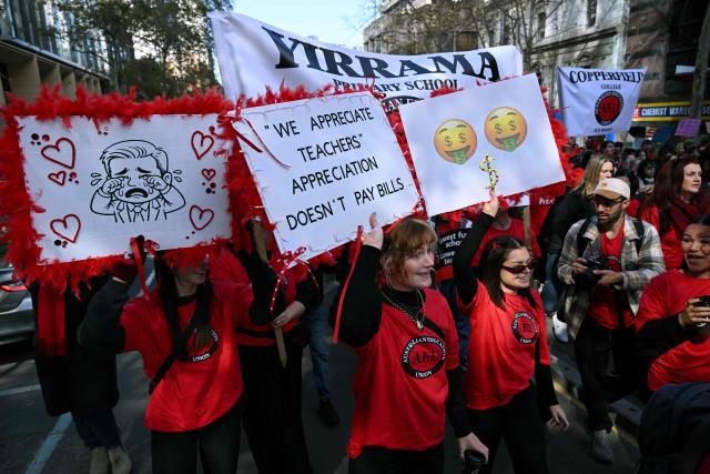 Teachers march through Melbourne's city centre to protest over pay and conditions on July 23, 2026. Tens of thousands of public school teachers went on strike following a pay dispute with the state government, closing or disrupting some 500 state schools. (Photo by William WEST / AFP)