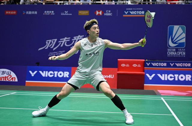 Lin Chun-Yi of Taiwan hits a return to Christo Popov of France during their men's singles round 16 match at the China Open badminton tournament in Changzhou, eastern China's Jiangsu province on July 23, 2026. (Photo by CN-STR / AFP) / China OUT