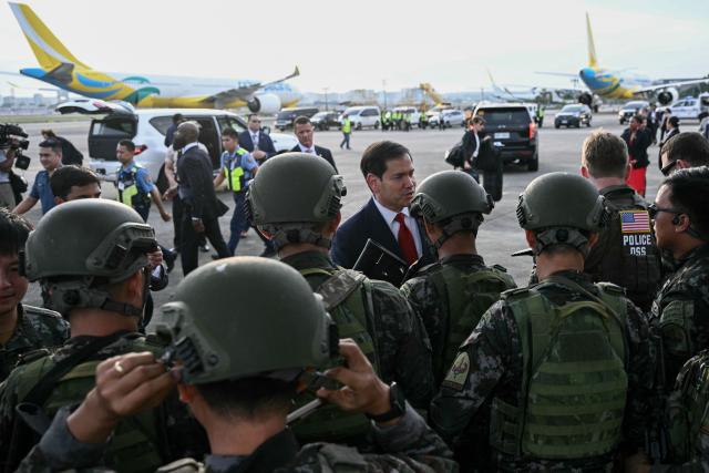 US Secretary of State Marco Rubio (C) meets members of the armed forces as he departs at Ninoy Aquino International Airport in Manila on July 23, 2026, following his visit to attend the Association of Southeast Asian Nations (ASEAN) Foreign Ministers Meeting. (Photo by Brendan SMIALOWSKI / POOL / AFP)