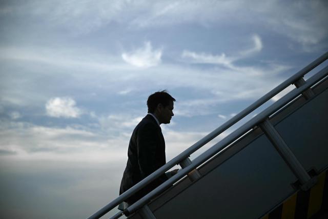 US Secretary of State Marco Rubio walks up the steps to his plane as he departs at Ninoy Aquino International Airport in Manila on July 23, 2026, following his visit to attend the Association of Southeast Asian Nations (ASEAN) Foreign Ministers Meeting. (Photo by Brendan SMIALOWSKI / POOL / AFP)