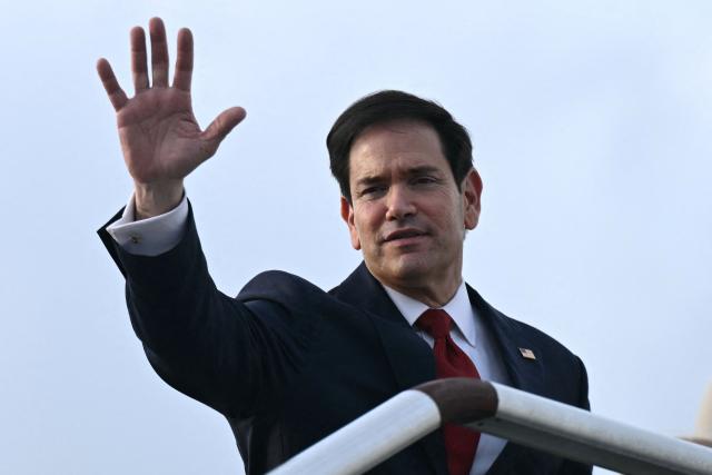 US Secretary of State Marco Rubio waves from the top of the steps to his plane as he departs at Ninoy Aquino International Airport in Manila on July 23, 2026, following his visit to attend the Association of Southeast Asian Nations (ASEAN) Foreign Ministers Meeting. (Photo by Brendan SMIALOWSKI / POOL / AFP)