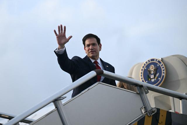 US Secretary of State Marco Rubio waves from the top of the steps to his plane as he departs at Ninoy Aquino International Airport in Manila on July 23, 2026, following his visit to attend the Association of Southeast Asian Nations (ASEAN) Foreign Ministers Meeting. (Photo by Brendan SMIALOWSKI / POOL / AFP)