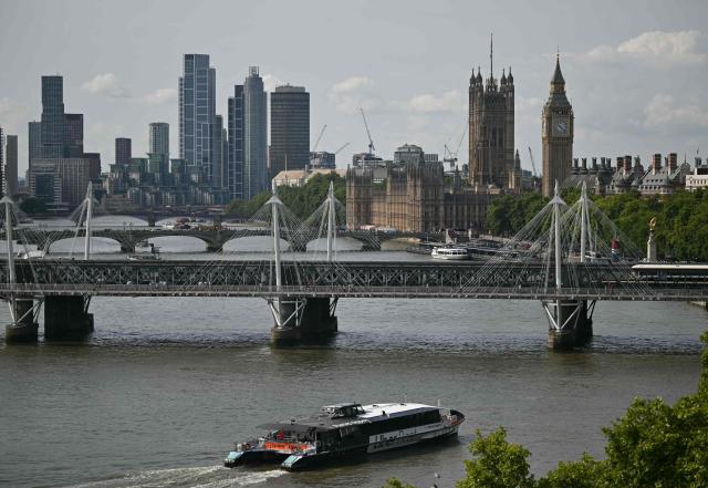 An Uber boat travels up the River Thames, towards the Palace of Westminster, home to the Houses of Parliament in central London on July 23, 2026. (Photo by JUSTIN TALLIS / AFP)