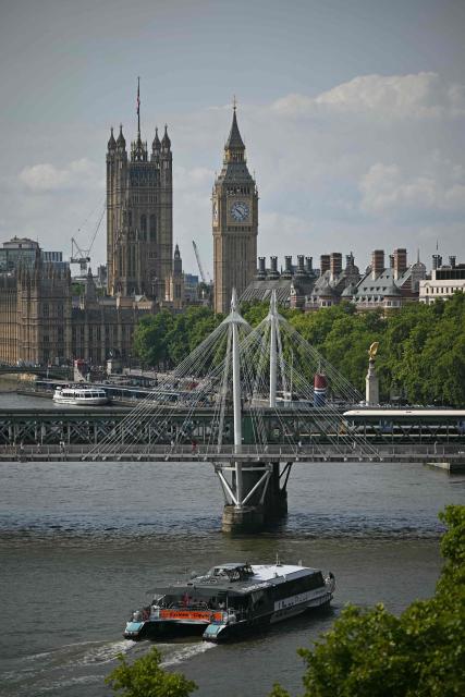 An Uber boat travels up the River Thames, towards the Palace of Westminster, home to the Houses of Parliament in central London on July 23, 2026. (Photo by JUSTIN TALLIS / AFP)