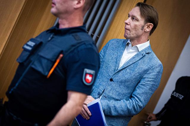 (FILES) Defendant Christian B (R) is brought to the courtroom for a session of his trial at court in Braunschweig, northern Germany, on September 25, 2024. A German man seen as the top suspect in the 2007 disappearance of British toddler Madeleine McCann is under investigation after an altercation with police officers in northern Germany, police said July 23, 2026. Christian Brueckner, named as a suspect in the McCann case but never charged, was involved in a "physical attack" on law enforcement officers in the city of Kiel on June 6, a police spokeswoman told AFP. The magazine Der Spiegel reported that Brueckner got into a tussle with police outside a supermarket after taking photos of the officers with his mobile phone. The officers objected to being photographed and Bruecker refused their demand that he hand over his phone, according to Der Spiegel. The Kiel police spokeswoman declined to provide details of the alleged incident to AFP, citing the ongoing investigation. But she said: "An officer sustained injuries during the incident". (Photo by Moritz Frankenberg / POOL / AFP)