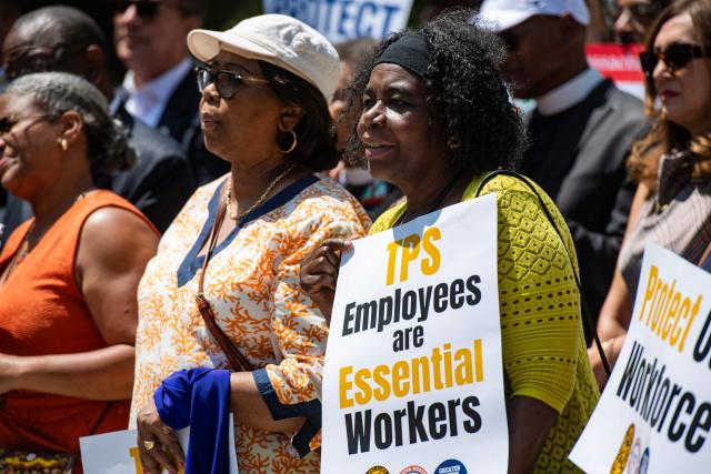 People hold signs at a rally calling on Congress to restore Temporary Protected Status (TPS) for Haitians, in Boston, Massachusetts, on July 23, 2026. The US Supreme Court on June 25, 2026, backed a Trump administration move to strip deportation protections from some 350,000 Haitians and 6,000 Syrians living in the United States. A federal appeals court on has extended the deadline for TPS to be revoked for Haitians in the US until July 27. (Photo by JOSEPH PREZIOSO / AFP)