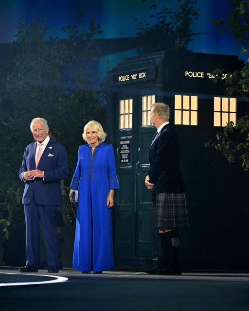 Britain's King Charles III and Britain's Queen Camilla react after departing a TARDIS alongside Scottish former cyclist Chris Hoy during the opening ceremony of the 23rd Commonwealth Games at the OVO Arena in Glasgow, Scotland, on July 23, 2026. (Photo by Oli SCARFF / AFP)