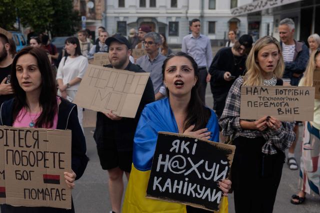 Protesters hold placards during on the eighth day of a demonstration against Ukraine's President's decision to dismiss Ukraine's former Defence Minister, in Kyiv on July 23, 2026, amid the Russian invasion of Ukraine. Ukraine's ex-defence minister -- whose ousting trigged a week of protests and forced out the country's commander-in-chief -- said on July 23, 2026, he was rejecting offers by Ukraine's President for a new role. (Photo by Tetiana DZHAFAROVA / AFP)