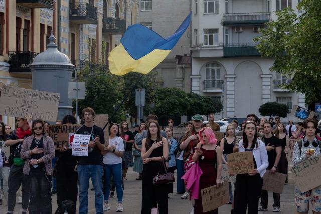 Protesters hold placards during on the eighth day of a demonstration against Ukraine's President's decision to dismiss Ukraine's former Defence Minister, in Kyiv on July 23, 2026, amid the Russian invasion of Ukraine. Ukraine's ex-defence minister -- whose ousting trigged a week of protests and forced out the country's commander-in-chief -- said on July 23, 2026, he was rejecting offers by Ukraine's President for a new role. (Photo by Tetiana DZHAFAROVA / AFP)