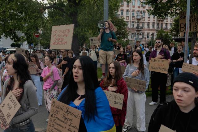 Protesters hold placards during on the eighth day of a demonstration against Ukraine's President's decision to dismiss Ukraine's former Defence Minister, in Kyiv on July 23, 2026, amid the Russian invasion of Ukraine. Ukraine's ex-defence minister -- whose ousting trigged a week of protests and forced out the country's commander-in-chief -- said on July 23, 2026, he was rejecting offers by Ukraine's President for a new role. (Photo by Tetiana DZHAFAROVA / AFP)