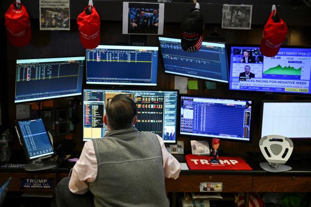 A trader works on the floor of the New York Stock Exchange (NYSE) in New York on July 23, 2026. Wall Street stocks tumbled on Thursday as oil prices shot higher on worsening effects of the US-Iran war while Tesla and Google parent Alphabet fell sharply after earnings reports.  International oil benchmark Brent North Sea crude topped $100 a barrel after Yemen's Iran-backed Houthi rebels struck oil tankers in the Red Sea. The attack brought the war roiling the Middle East to a new front. (Photo by ANGELA WEISS / AFP)