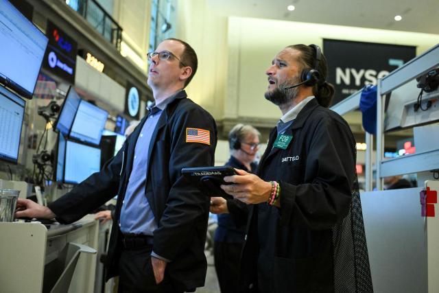 Traders work on the floor of the New York Stock Exchange (NYSE) in New York on July 23, 2026. Wall Street stocks tumbled on Thursday as oil prices shot higher on worsening effects of the US-Iran war while Tesla and Google parent Alphabet fell sharply after earnings reports.  International oil benchmark Brent North Sea crude topped $100 a barrel after Yemen's Iran-backed Houthi rebels struck oil tankers in the Red Sea. The attack brought the war roiling the Middle East to a new front. (Photo by ANGELA WEISS / AFP)
