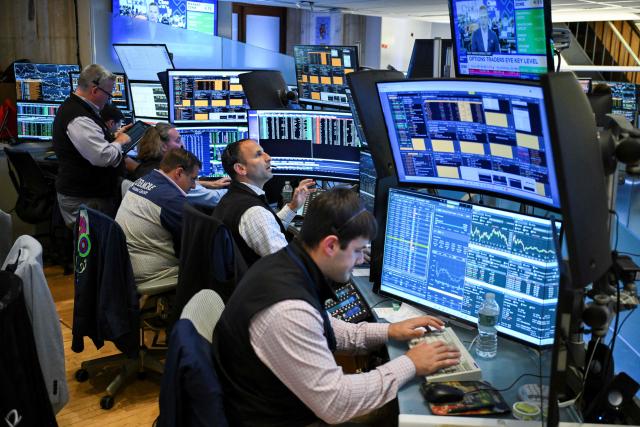 Traders work on the floor of the New York Stock Exchange (NYSE) in New York on July 23, 2026. Wall Street stocks tumbled on Thursday as oil prices shot higher on worsening effects of the US-Iran war while Tesla and Google parent Alphabet fell sharply after earnings reports.  International oil benchmark Brent North Sea crude topped $100 a barrel after Yemen's Iran-backed Houthi rebels struck oil tankers in the Red Sea. The attack brought the war roiling the Middle East to a new front. (Photo by ANGELA WEISS / AFP)