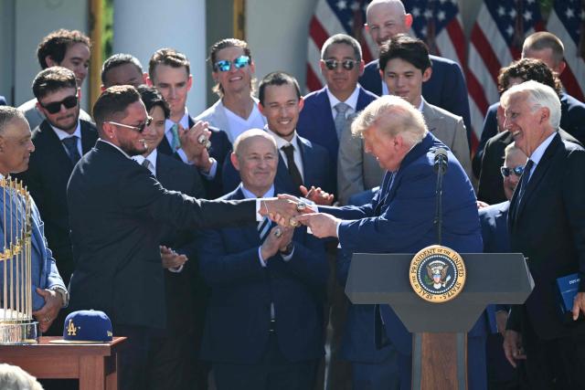 US President Donald Trump shakes hands with Los Angeles Dodgers player Miguel Rojas during a ceremony to honor the 2025 World Series champions in the Rose Garden at the White House in Washington, DC, on July 23, 2026. (Photo by SAUL LOEB / AFP)