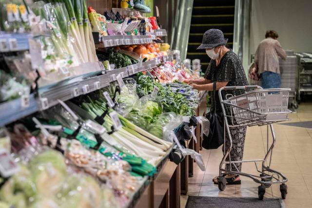A customer shops for groceries at a supermarket in Tokyo on July 24, 2026. (Photo by Yuichi YAMAZAKI / AFP)