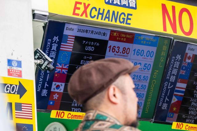 A man walks past a display showing currency rates at a money exchange in Shinjuku district in Tokyo on July 24, 2026. Core inflation accelerated in Japan in June, official data showed as the Middle East war and a weak yen pushed up prices for consumers in the world's fourth-biggest economy. A falling yen, which overnight hit a fresh four-decade low against the US dollar, also increases the cost of imports like oil and food for resource-poor Japan. (Photo by Andrew CABALLERO-REYNOLDS / AFP)