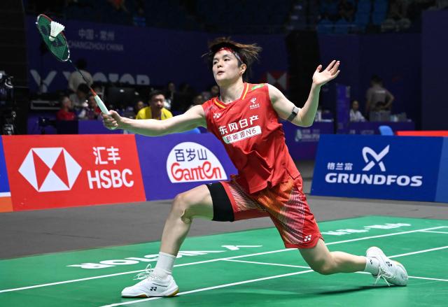 China's Wang Zhiyi hits a return to South Korea's Kim Ga-eun during their women's singles quarter final match at the China Open badminton tournament in Changzhou, eastern China's Jiangsu province on July 24, 2026. (Photo by CN-STR / AFP) / China OUT
