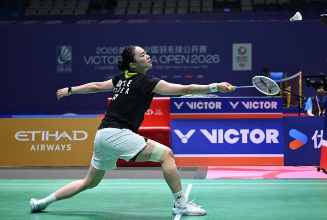 South Korea's Kim Ga-eun hits a return to China's Wang Zhiyi during their women's singles quarter final match at the China Open badminton tournament in Changzhou, eastern China's Jiangsu province on July 24, 2026. (Photo by CN-STR / AFP) / China OUT