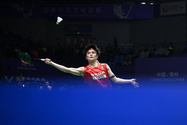 China's Wang Zhiyi hits a return to South Korea's Kim Ga-eun during their women's singles quarter final match at the China Open badminton tournament in Changzhou, eastern China's Jiangsu province on July 24, 2026. (Photo by CN-STR / AFP) / China OUT