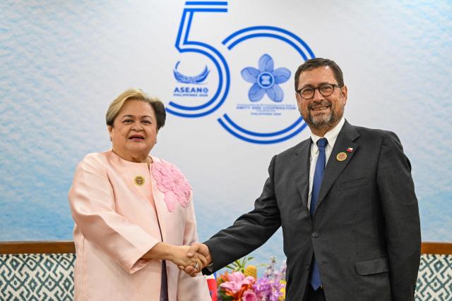 Philippine Foreign Affairs Secretary Theresa Lazaro (L) and Chile Foreign Affairs Minister Francisco Perez Mackenna (R) shake hands during a bilateral meeting on the sidelines of the Association of Southeast Asian Nations (ASEAN) foreign ministers' meetings in Pasay City, Metro Manila on July 24, 2026. (Photo by JAM STA ROSA / POOL / AFP)
