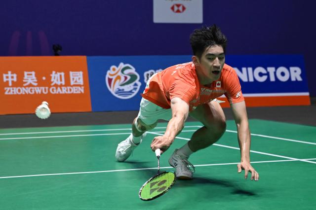 Canada's Victor Lai hits a return to Indonesia's Jonatan Christie during their men's singles quarter final match at the China Open badminton tournament in Changzhou, eastern China's Jiangsu province on July 24, 2026. (Photo by CN-STR / AFP) / China OUT