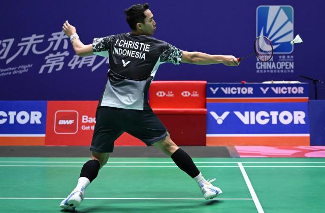 Indonesia's Jonatan Christie hits a return to Canada's Victor Lai during their men's singles quarter final match at the China Open badminton tournament in Changzhou, eastern China's Jiangsu province on July 24, 2026. (Photo by CN-STR / AFP) / China OUT