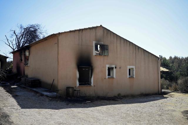 This photo shows a house devastated by a wildfire in Cotignac south-eastern France on July 24, 2026. Firefighters in the Var are hoping for “favourable” weather on July 24, 2026 so that they can tackle the numerous flare-ups from the previous day in the Correns area, where hundreds of people had to be evacuated. (Photo by Frederic DIDES / AFP)