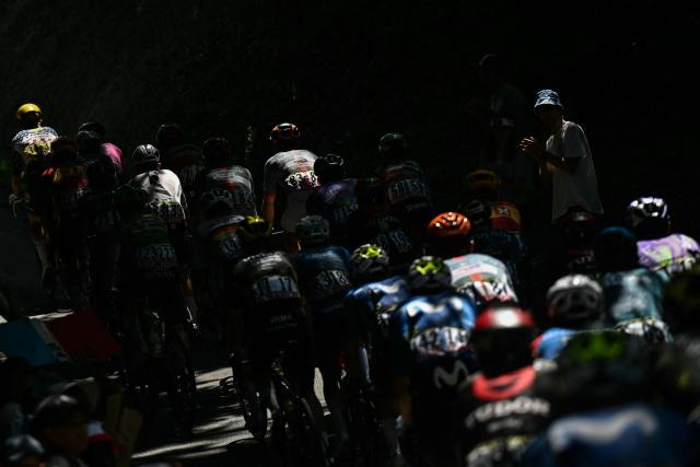 The pack of riders (peloton) cycles during the 19th stage of the 113th edition of the Tour de France cycling race, 127,9 km between Gap and Alpe d'Huez in the French Alps, on July 24, 2026. (Photo by Loic VENANCE / AFP)