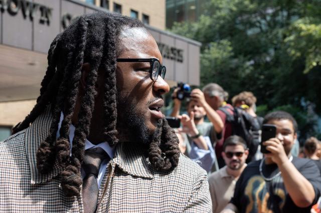 Omololu Omari Akinlolu, a co-defendant along with US singer Chris Brown departs after attending a hearing at Southwark Crown Court in London on July 24, 2026. Brown and Omololu Omari Akinlolu, a co-defendant, on July 24, 2026, pleaded guilty to a public order offence following an alleged brawl at a London nightclub in 2023. "Guilty," replied Brown, 37, dressed in a beige suit and dark tie, after the charge of affray was put to him as he stood in the dock at Southwark Crown Court in London. (Photo by Brook Mitchell / AFP)