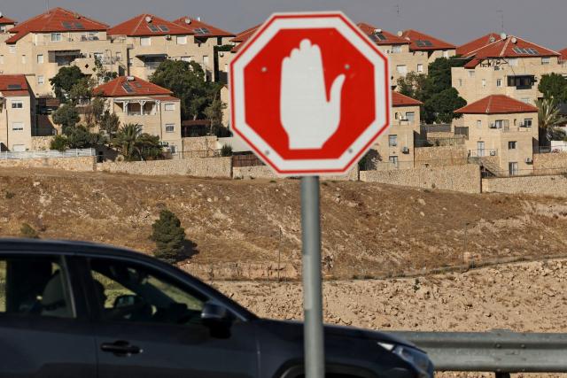 A car drives past the Israeli settlement of Maale Adumim in the Israeli occupied Palestinian West Bank, some seven kilometers east of Jerusalem, on July 24, 2026. The Israeli prime minister ordered the establishment of new settler outposts in the occupied West Bank on July 24. All Israeli settlements are illegal under international law, while outposts are small settlements established usually without government approval and therefore illegal under Israeli law. (Photo by AHMAD GHARABLI / AFP)