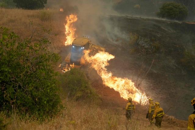 Firefighters battle a wildfire in Cebreros area, near Avila, 80 kms west of Madrid on July 24, 2026. Spain declared a national emergency in the Madrid region and in the province of Avila, near the capital, on July 23, 2026, in the wake of several wildfires burning out of control. Scientists have long warned that climatechange caused by human use of fossil fuels will make periods of drought more intense and longer-lasting, creating the ideal conditions for wildfires. (Photo by Cesar MANSO / AFP)